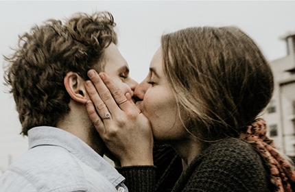 close-up of white man woman kissing